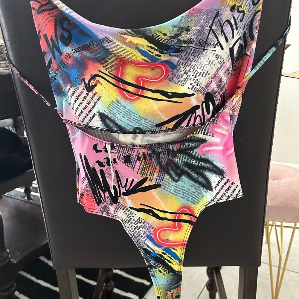 Sleek colorful graffiti body suit.